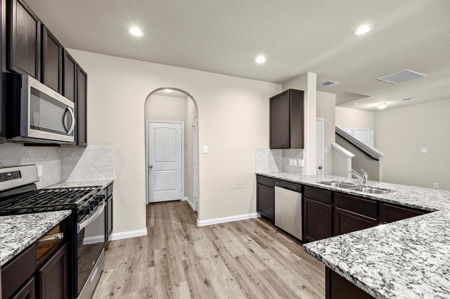 Kitchen looking into Door to Pantry and Garage