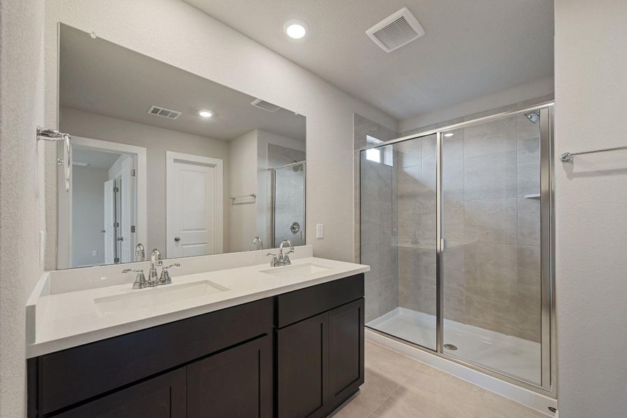 Primary Bath retreat with dual vanities & walk-in shower - Representative Photo