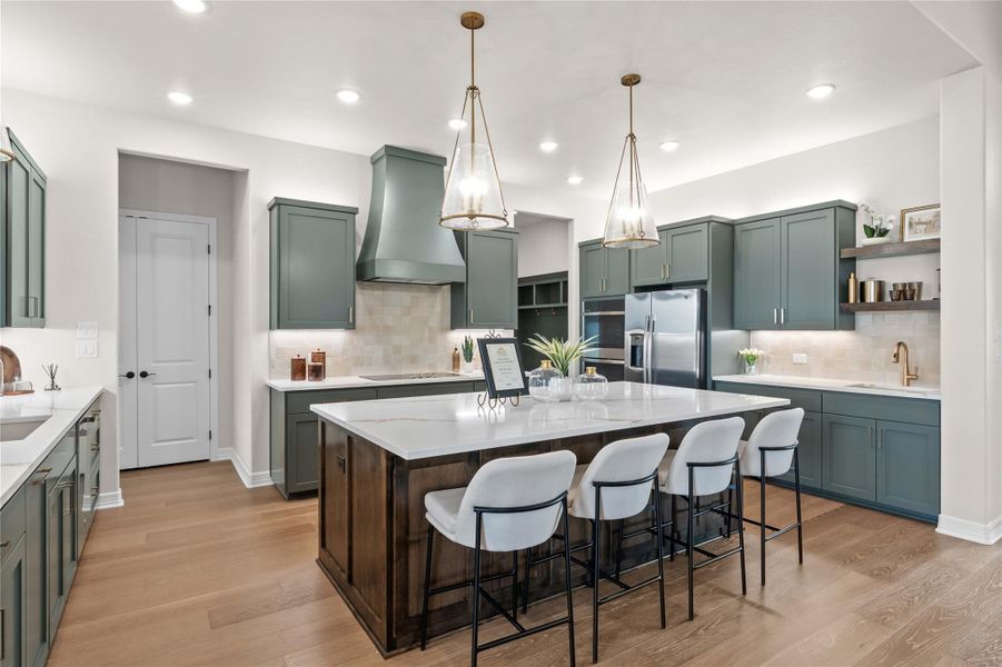An inviting kitchen with a central island and rich cabinetry creates a perfect gathering space. An inviting kitchen with a central island and rich cabinetry creates a perfect gathering space.