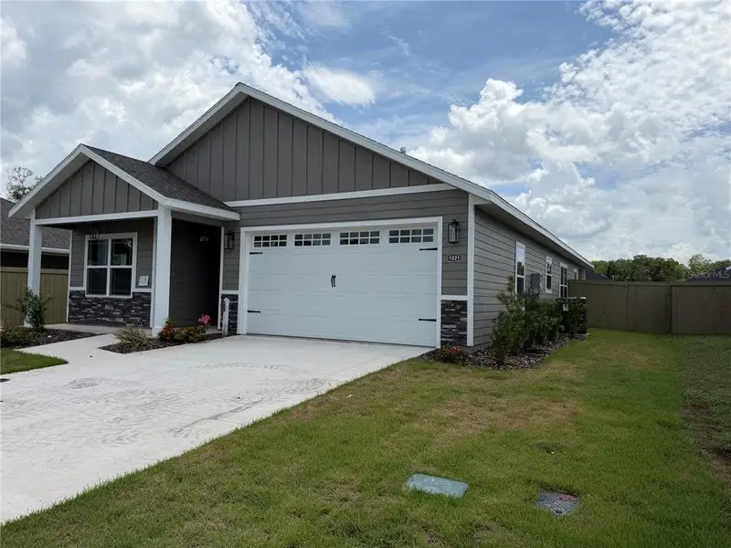 Front exterior of a new home in , Newberry, FL, highlighting curb appeal (Image 1). Front exterior of a new home in , Newberry, FL, highlighting curb appeal (Image 1).