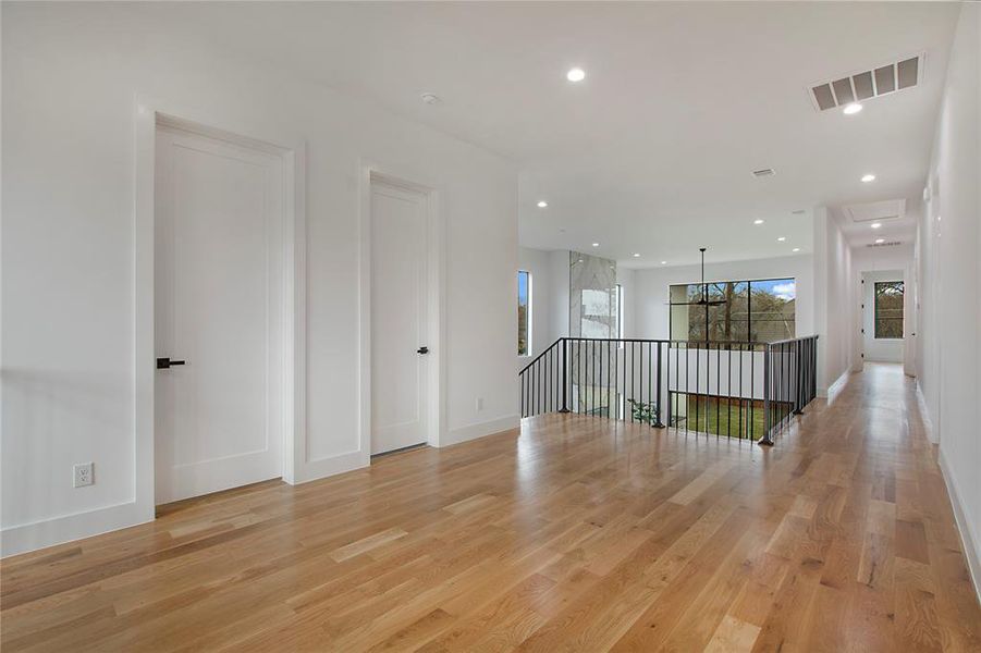 Empty room with light hardwood / wood-style flooring