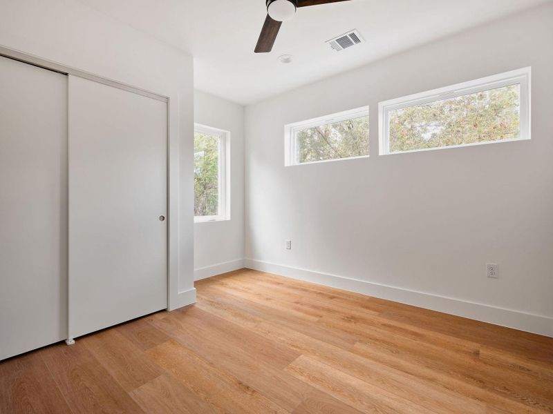 Unfurnished bedroom featuring a closet, light wood-style floors, and ceiling fan Unfurnished bedroom featuring a closet, light wood-style floors, and ceiling fan
