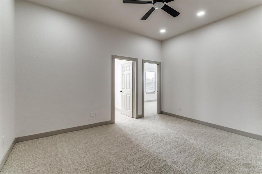 Empty room with light carpet, ceiling fan, and recessed lighting Empty room with light carpet, ceiling fan, and recessed lighting