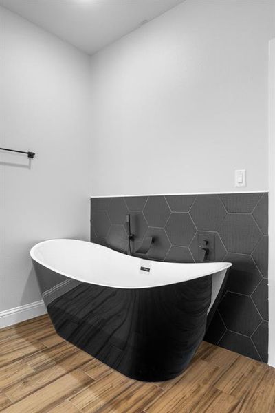 Bathroom featuring a tub to relax in