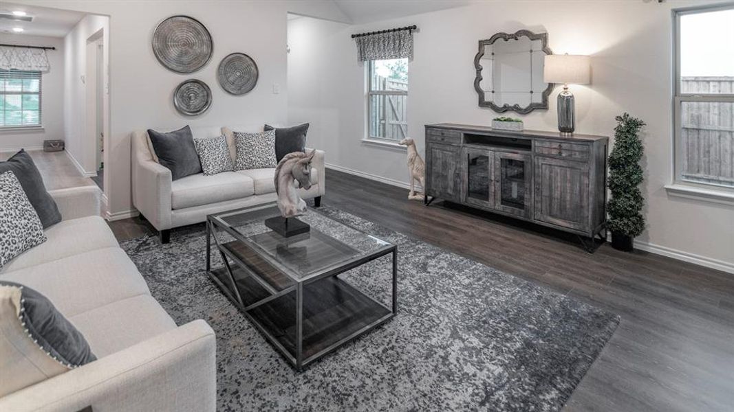 Living room with dark wood finished floors and lofted ceiling