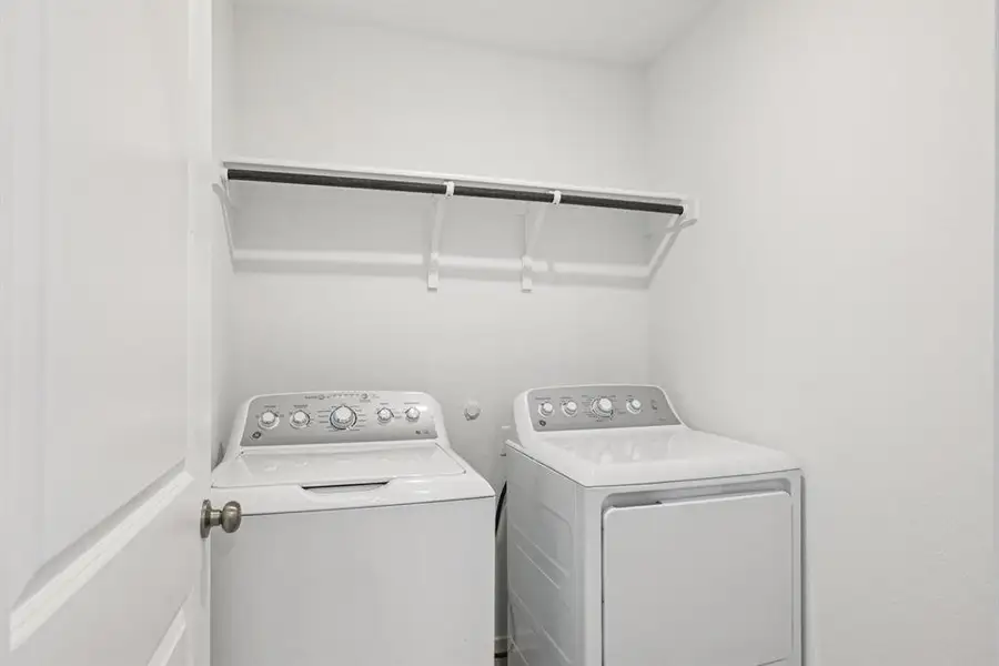 Laundry area with washer and clothes dryer