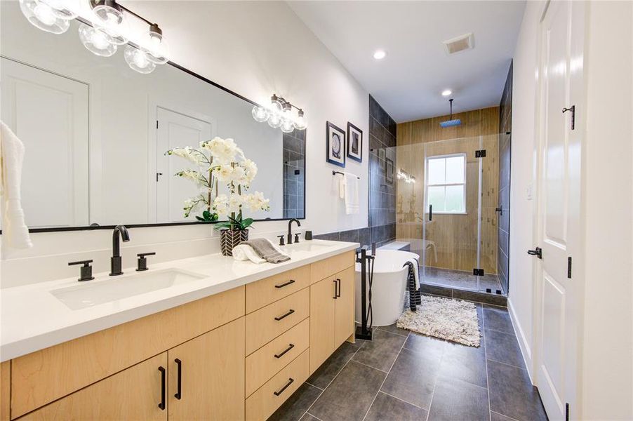 Primary Bathroom. Features soaker tub and custom tiled oversized shower with ribbon oak tile accent wall!