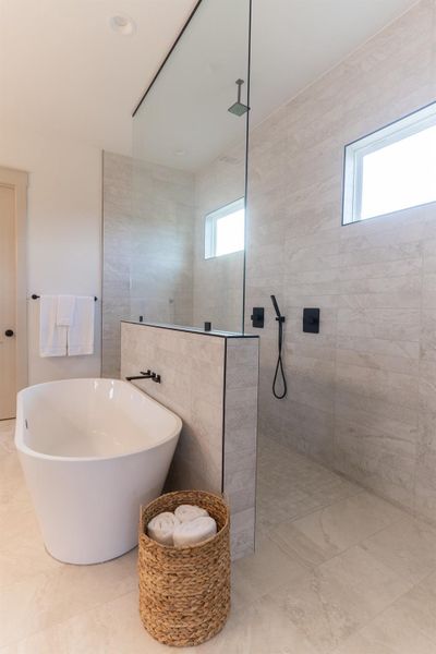 Bathroom featuring a walk in shower and a soaking tub Bathroom featuring a walk in shower and a soaking tub