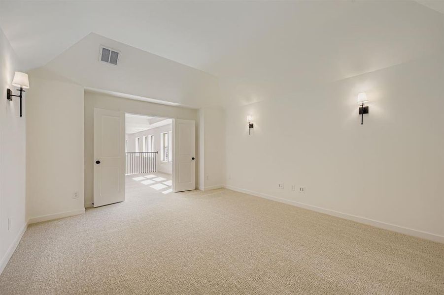Unfurnished room featuring light colored carpet and baseboards