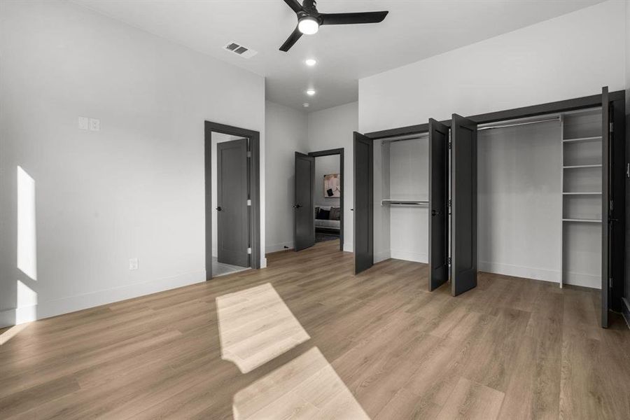 Unfurnished bedroom with light wood-type flooring, a ceiling fan, and recessed lighting
