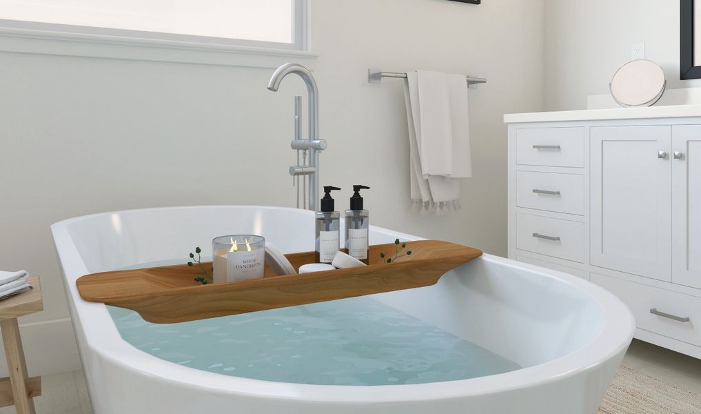 Primary suite bath tub with chrome faucet and fixtures