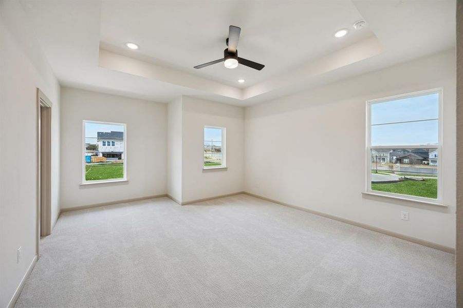 Featuring tray ceilings, plush carpet and plenty of windows, this owner's suite does not disappoint!