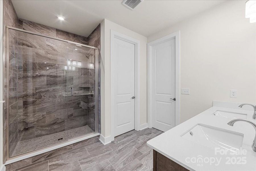 En Suite Primary Bath with Modern Tile Design.