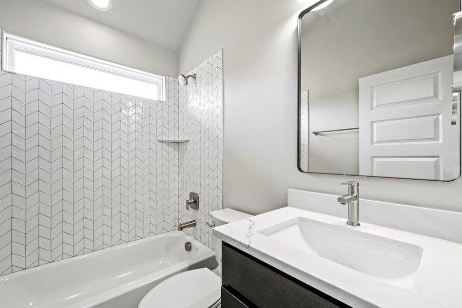 Full bathroom featuring toilet, bathtub / shower combination, and vanity Full bathroom featuring toilet, bathtub / shower combination, and vanity