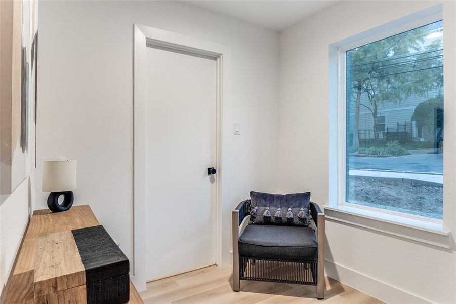 Sitting room with light hardwood / wood-style flooring