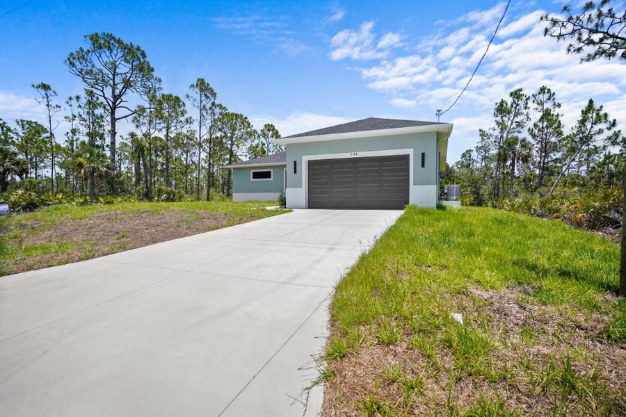 Front exterior of a new home in , Port Charlotte, FL, highlighting curb appeal (Image 1). Front exterior of a new home in , Port Charlotte, FL, highlighting curb appeal (Image 1).