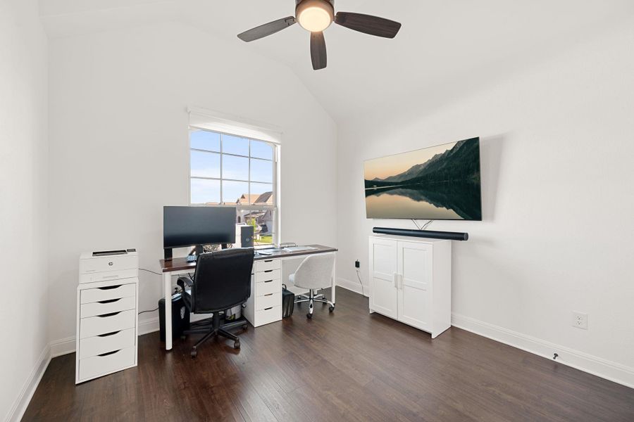 A versatile home office featuring rich hard surfaced flooring and a vaulted ceiling. A versatile home office featuring rich hard surfaced flooring and a vaulted ceiling.