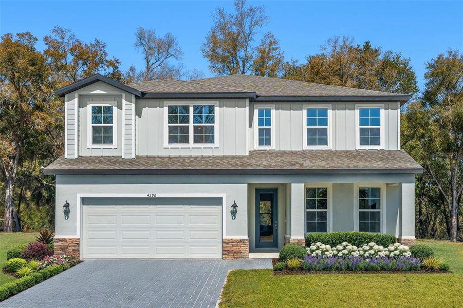 Front exterior of a new home in Estes Reserve, Eustis, FL, highlighting curb appeal (Image 1). Front exterior of a new home in Estes Reserve, Eustis, FL, highlighting curb appeal (Image 1).
