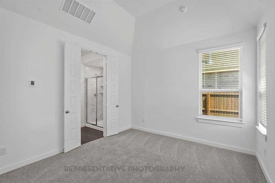 Unfurnished bedroom featuring carpet floors and connected bathroom