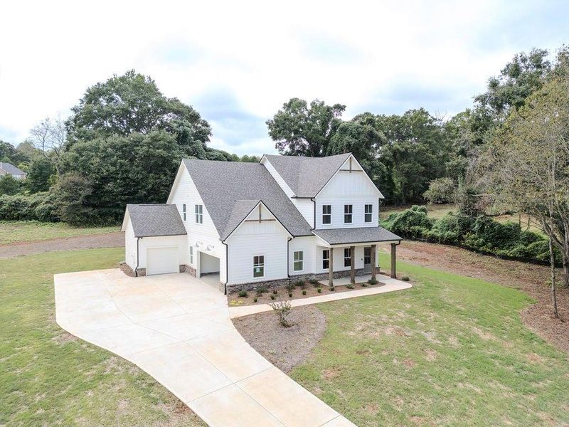 Front exterior of a new home in , Hoschton, GA, highlighting curb appeal (Image 29).