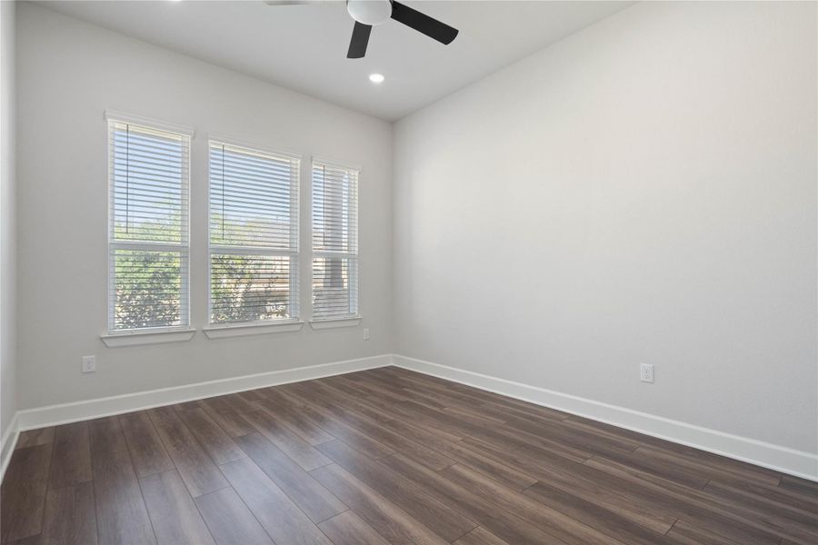 Rich wood floors and clean baseboards ground this versatile interior space.