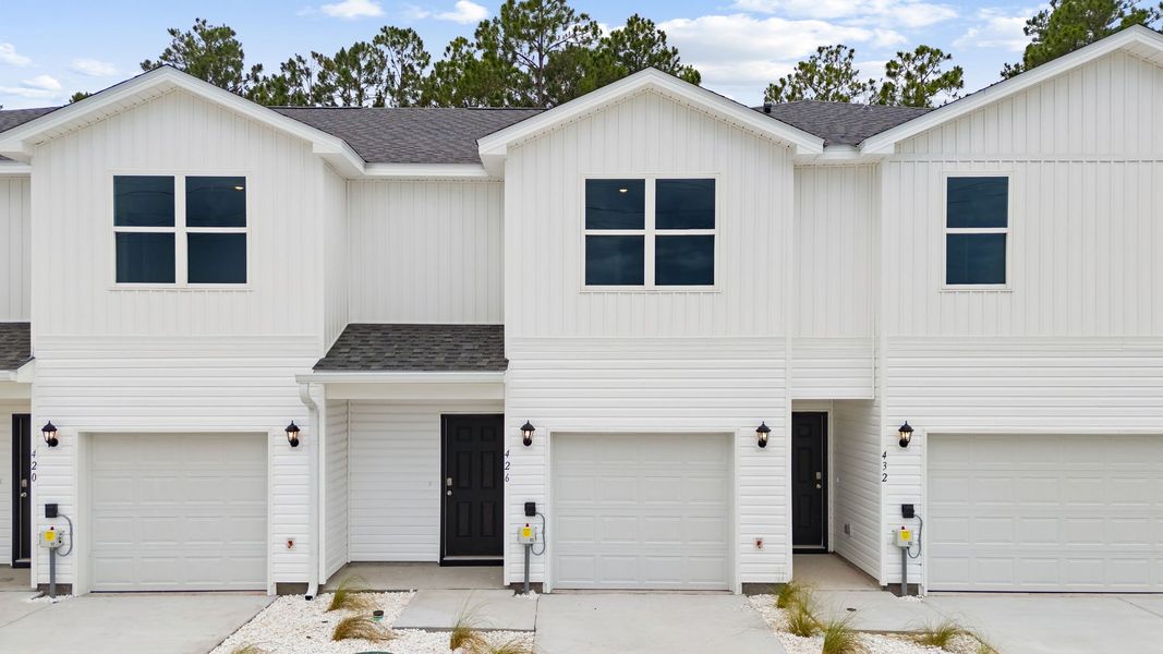 Front exterior of a new home in Chateau Nemours, Port Saint Joe, FL, highlighting curb appeal (Image 1). Front exterior of a new home in Chateau Nemours, Port Saint Joe, FL, highlighting curb appeal (Image 1).