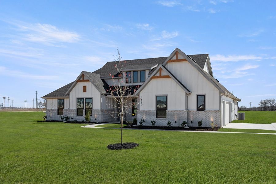 Front exterior of a new home in Estates of Palmer, Waxahachie, TX, highlighting curb appeal (Image 2). Front exterior of a new home in Estates of Palmer, Waxahachie, TX, highlighting curb appeal (Image 2).