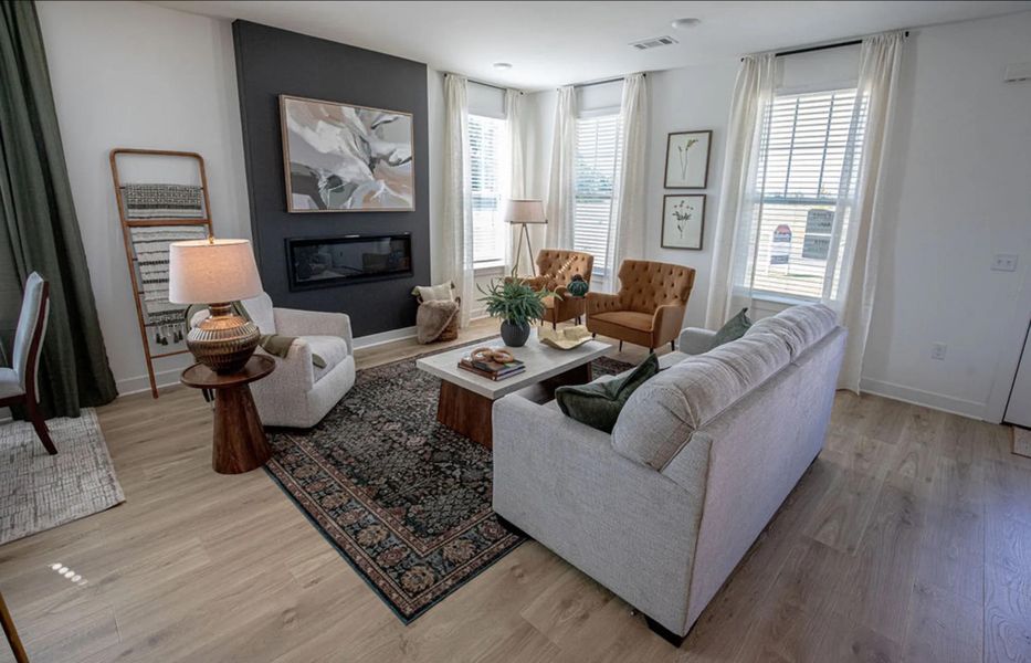 Living area featuring a glass covered fireplace and light wood finished floors