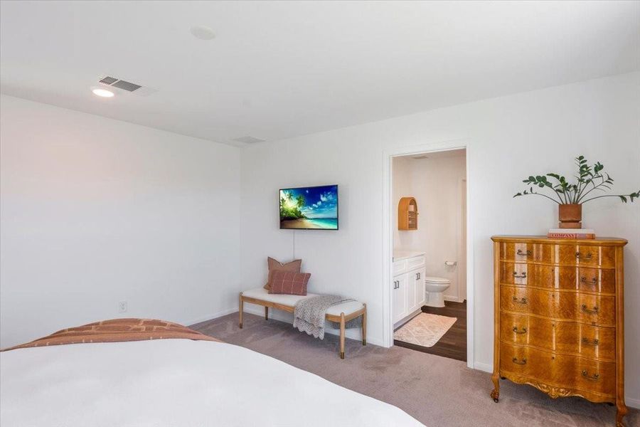 Another view of the primary bedroom looking into the primary bathroom. Another view of the primary bedroom looking into the primary bathroom.