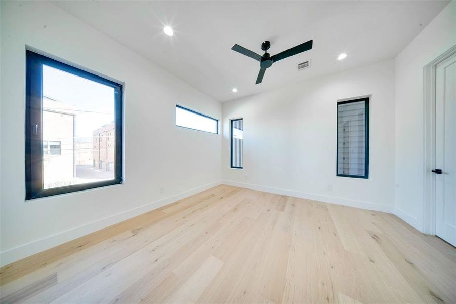 Unfurnished room with light hardwood / wood-style floors and ceiling fan