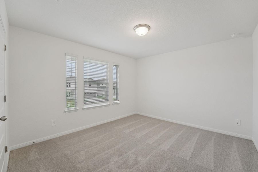 Carpeted spare room with baseboards