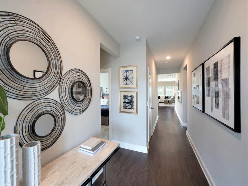 Right off the foyer, additional bedrooms are separated from the primary suite.