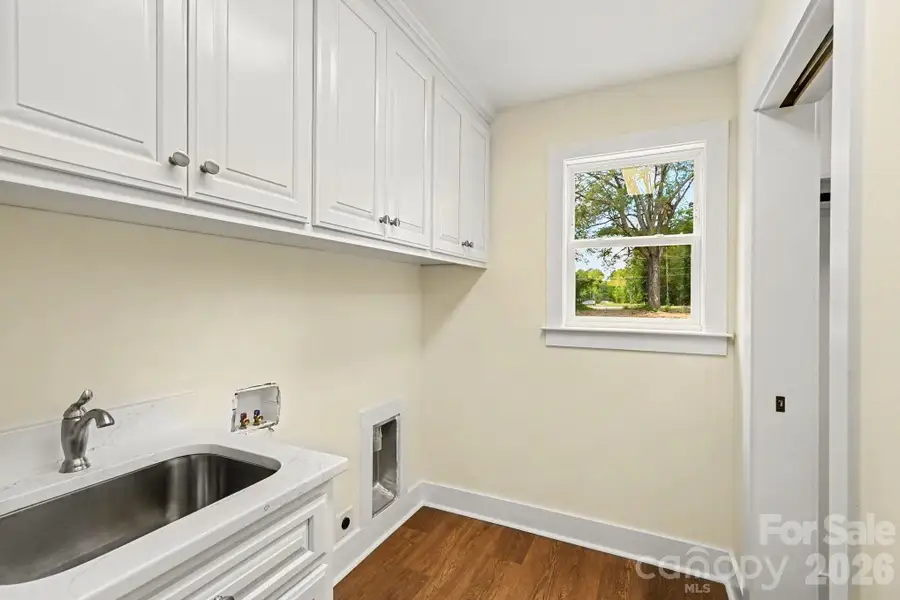 Laundry room with storage cabinets and extra sink Laundry room with storage cabinets and extra sink