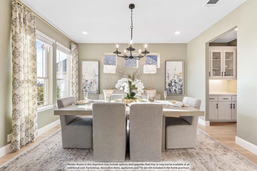 Formal dining room with rectangular table, gray upholstered chairs, chandelier, and hardwood floors