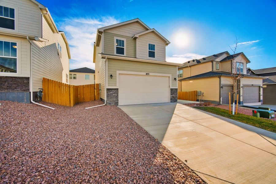 Front exterior of a new home in Ridge at Lorson Ranch, Colorado Springs, CO, highlighting curb appeal (Image 2).