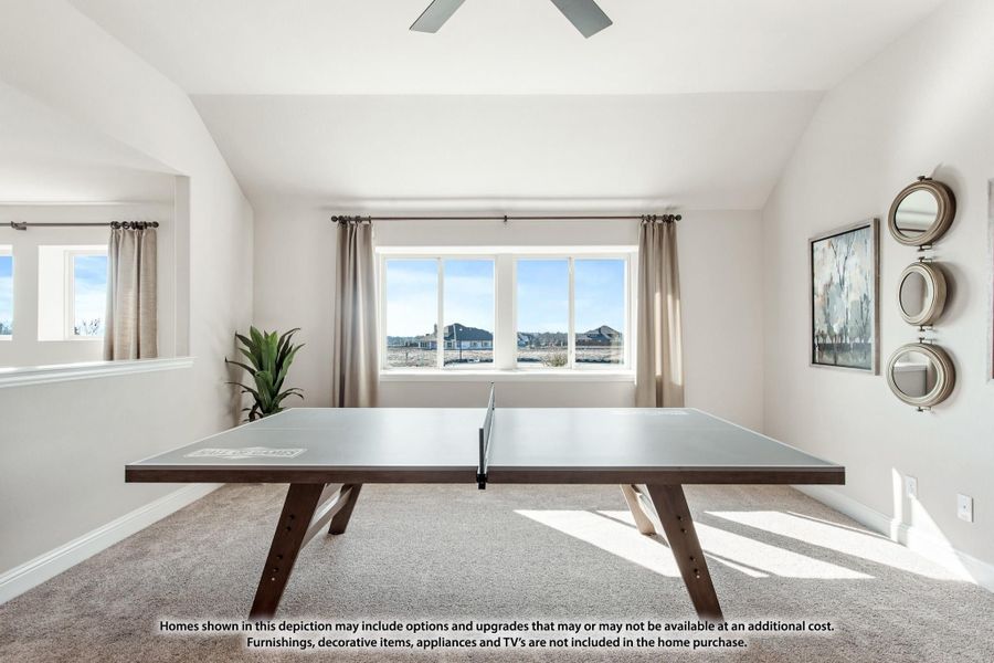 Bonus room with ping pong table, carpet flooring, ceiling fan, and large windows with outdoor views Bonus room with ping pong table, carpet flooring, ceiling fan, and large windows with outdoor views