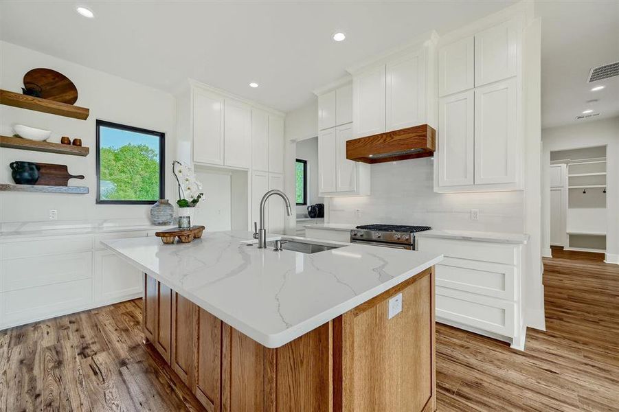 Floor to ceiling cabinetry, quartz countertops, stainless appliances