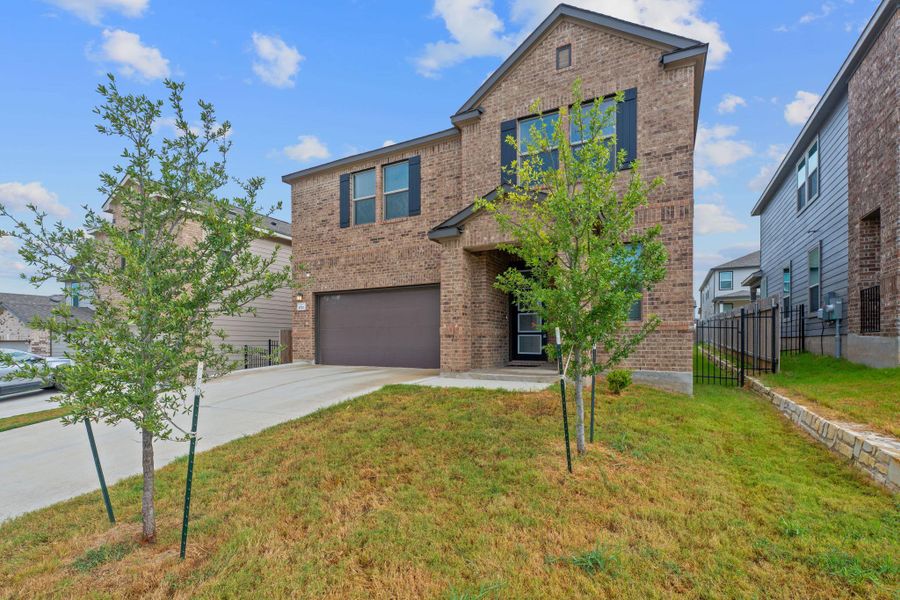 Front exterior of a new home in EastVillage - Heritage Collection, Manor, TX, highlighting curb appeal (Image 25). Front exterior of a new home in EastVillage - Heritage Collection, Manor, TX, highlighting curb appeal (Image 25).