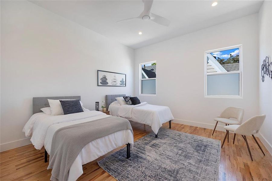 Bedroom featuring ceiling fan and light hardwood / wood-style flooring