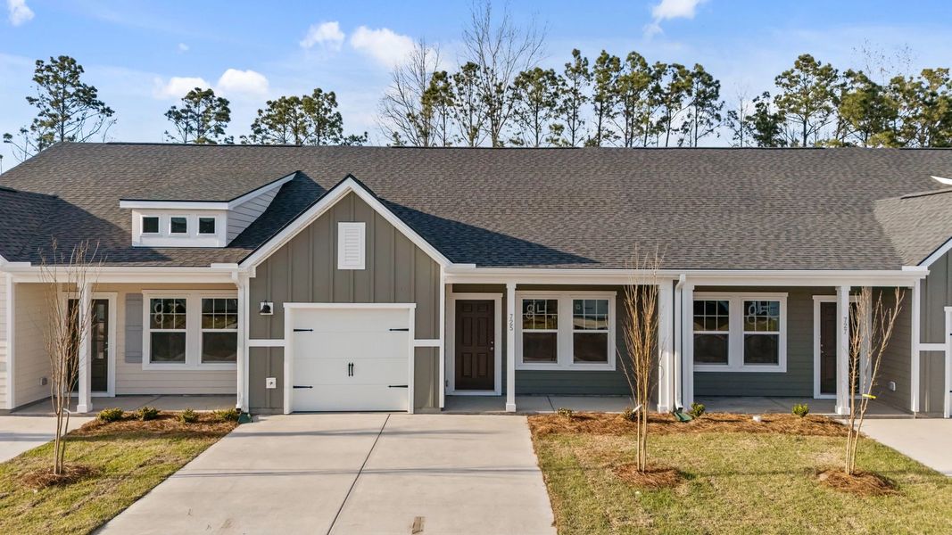 Front exterior of a new home in Blue Heron Retreat, Little River, SC, highlighting curb appeal (Image 1). Front exterior of a new home in Blue Heron Retreat, Little River, SC, highlighting curb appeal (Image 1).