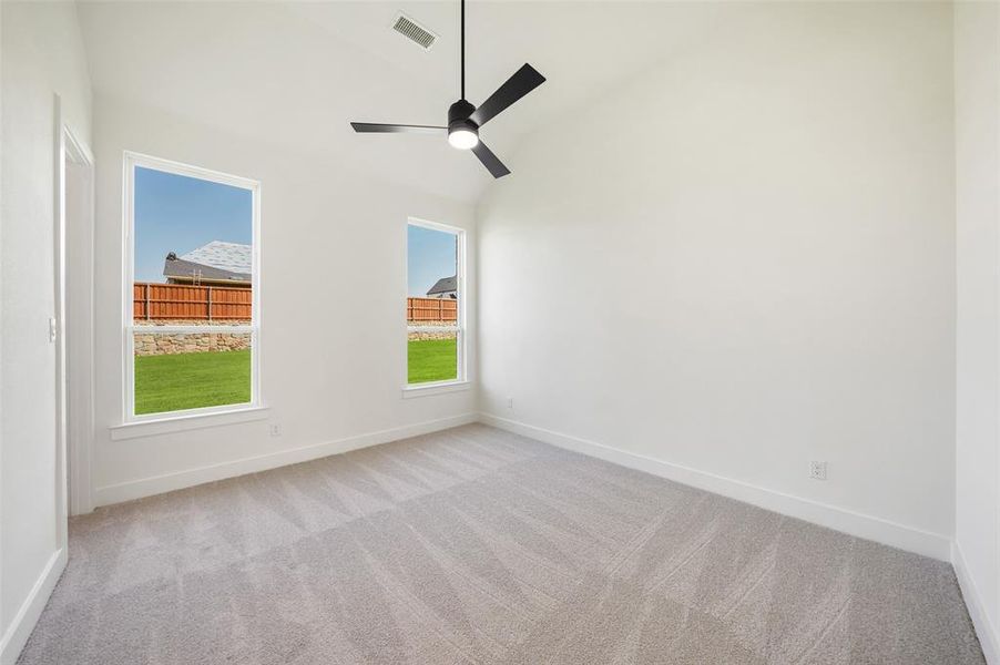 Unfurnished room featuring light carpet, ceiling fan, and high vaulted ceiling