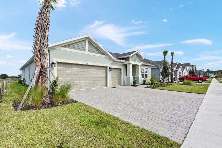 Front exterior of a new home in Ardisia Park, New Smyrna Beach, FL, highlighting curb appeal (Image 25).
