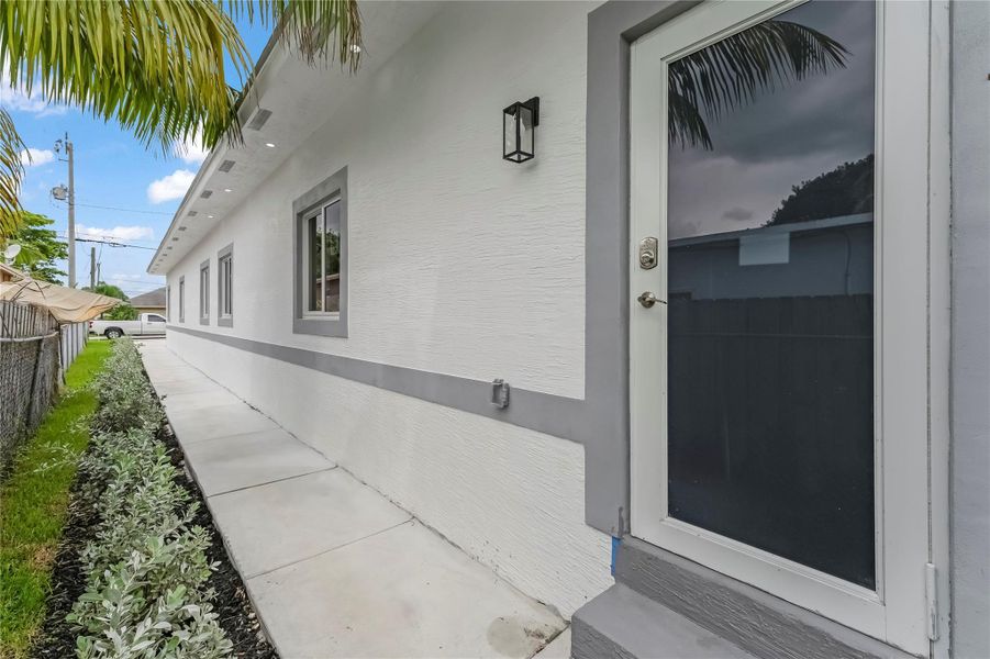 Front exterior of a new home in , West Park, FL, highlighting curb appeal (Image 14).