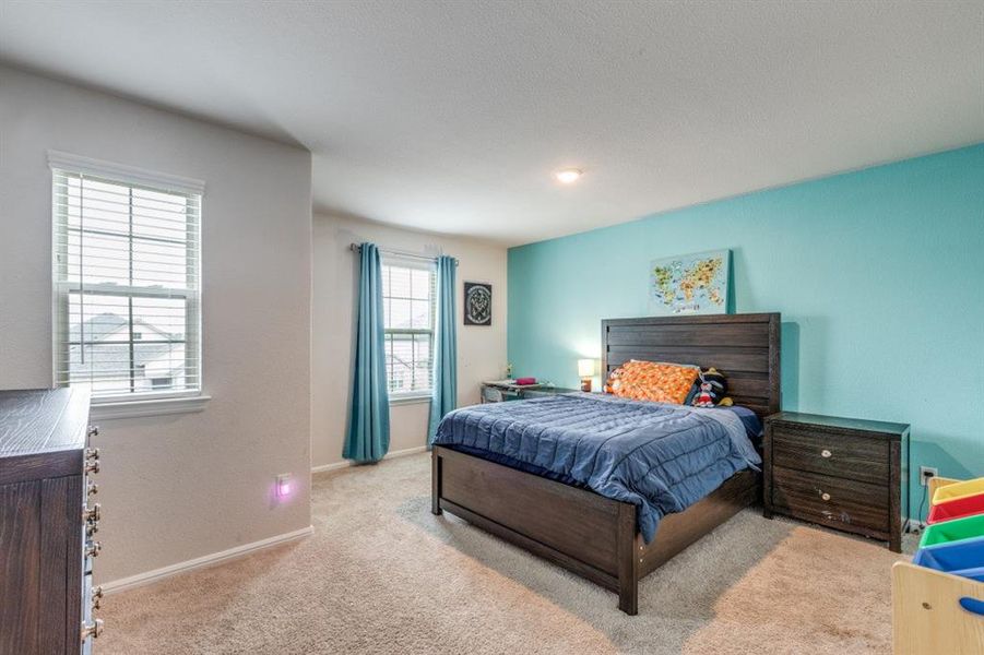 Bedroom featuring carpet flooring and baseboards