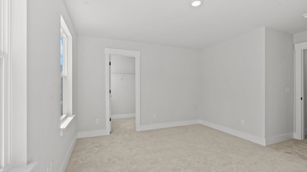 Refined bedroom design with large windows for daylight-filled mornings and peaceful views