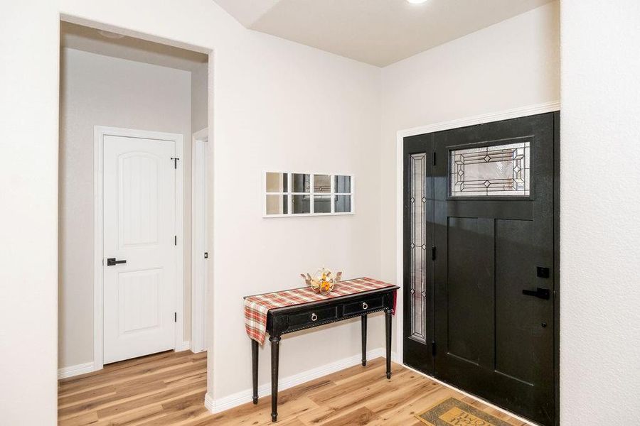 Entryway with hardwood / wood-style flooring