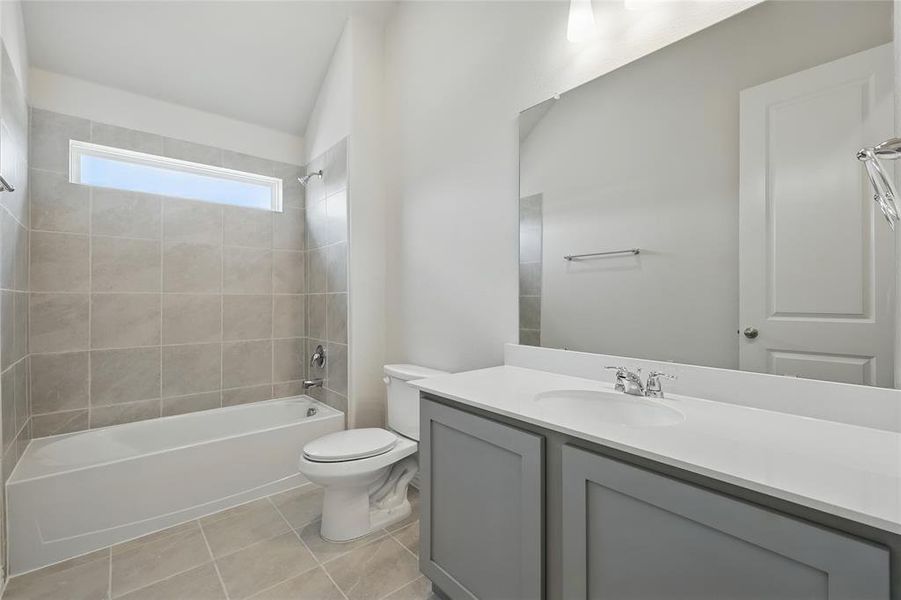 Full bath featuring vanity, shower / washtub combination, and light tile patterned floors