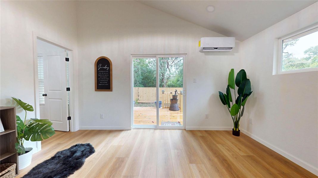 Primary bedroom has high vaulted ceilings