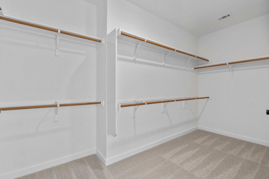 Walk-in closet in Primary Bedroom Walk-in closet in Primary Bedroom