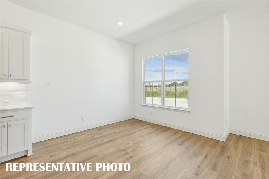 This dining area features oversized windows and space for a table large enough to seat the entire family!  REPRESENTATIVE PHOTO